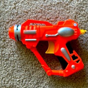 Small orange toy gun.